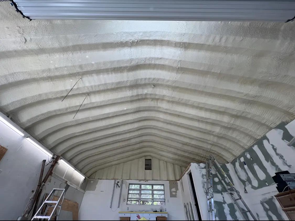 Spray polyurethane foam applied to the underside of a metal roof deck in Lovington